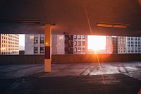 Sun peeking through an empty city car park next to buildings in Salt Lake City. Original public domain image from Wikimedia Commons