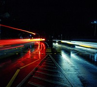 Multi-lane bridge at night with car light trails. Original public domain image from Wikimedia Commons