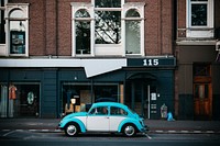 White blue vintage car parked on the street. Original public domain image from Wikimedia Commons