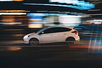 A long exposure of a car driving in Wencheng at night with lights around it. Original public domain image from Wikimedia Commons