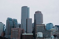 Boston city skyscrapers against a gray, overcast sky. Original public domain image from <a href="https://commons.wikimedia.org/wiki/File:Boston_city_skyline_(Unsplash).jpg" target="_blank" rel="noopener noreferrer nofollow">Wikimedia Commons</a>