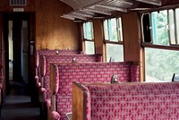 Interior of the old vintage British railway passenger carriage with wooden benches in Ropley. Original public domain image from <a href="https://commons.wikimedia.org/wiki/File:Vintage_British_railway_carriage_interior_(Unsplash).jpg" target="_blank" rel="noopener noreferrer nofollow">Wikimedia Commons</a>