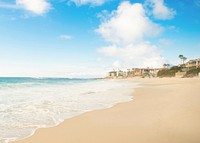 View of the coastal houses from the sand beach by the ocean. Original public domain image from Wikimedia Commons