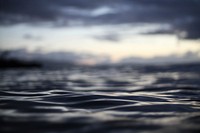 Close up of the dark ocean waters of Waimea Bay under a cloudy sunset. Original public domain image from Wikimedia Commons