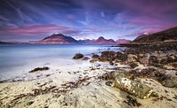 View of the mountain range from rocky sand beach in Elgol Village, Scotland. Original public domain image from Wikimedia Commons