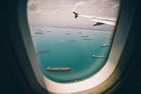 Airplane window with sea view. Original public domain image from Wikimedia Commons