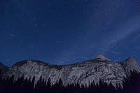 A granite cliff in Yosemite under a starry night sky. Original public domain image from <a href="https://commons.wikimedia.org/wiki/File:Yosemite_cliff_under_stars_(Unsplash).jpg" target="_blank" rel="noopener noreferrer nofollow">Wikimedia Commons</a>