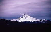 A tall mountain peak with a thick layer of snow on its sides on a cloudy day. Original public domain image from <a href="https://commons.wikimedia.org/wiki/File:Tall_peak_under_overcast_sky_(Unsplash).jpg" target="_blank" rel="noopener noreferrer nofollow">Wikimedia Commons</a>