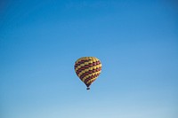 A colorful hot air balloon soaring high up in the sky. Original public domain image from <a href="https://commons.wikimedia.org/wiki/File:Hot_air_balloon_in_blue_sky_(Unsplash).jpg" target="_blank" rel="noopener noreferrer nofollow">Wikimedia Commons</a>
