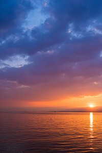 A blue, purple, and orange sunset over the ocean. Original public domain image from Wikimedia Commons