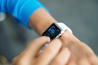 Person checks stats on the screen of their apple watch. Original public domain image from Wikimedia Commons