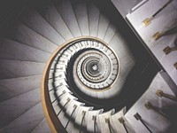 Impressive view down a stairwell with spiral marble stairs. Original public domain image from <a href="https://commons.wikimedia.org/wiki/File:Infinite_spiral_stairs_(Unsplash).jpg" target="_blank" rel="noopener noreferrer nofollow">Wikimedia Commons</a>