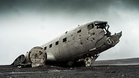 A broken, strange and crashed plane on a sandy floor. Original public domain image from Wikimedia Commons