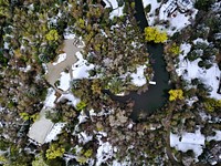A drone shot of Salt Lake City, Utah showing trees, water, streets and snow. Original public domain image from Wikimedia Commons
