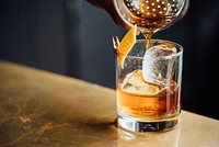 Liquor pouring on clear shot glass. Original public domain image from Wikimedia Commons