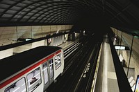 Bullet train leaves the platform in the city. Original public domain image from Wikimedia Commons