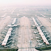 Aerial view of airport with lots of airplanes. Original public domain image from <a href="https://commons.wikimedia.org/wiki/File:Skyler_Smith_2016_(Unsplash).jpg" target="_blank">Wikimedia Commons</a>