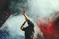 Musician reaching out hand while singing on stage during a show. Original public domain image from Wikimedia Commons