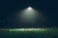 A soccer game being played at night under floodlights. Original public domain image from <a href="https://commons.wikimedia.org/wiki/File:Soccer_at_night_(Unsplash).jpg" target="_blank" rel="noopener noreferrer nofollow">Wikimedia Commons</a>