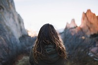 Woman with wavy hair exploring the mountains on a hike alone. Original public domain image from <a href="https://commons.wikimedia.org/wiki/File:Mountain_Hikes_Alone_(Unsplash).jpg" target="_blank" rel="noopener noreferrer nofollow">Wikimedia Commons</a>