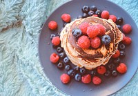 Blueberries and raspberries on a stack of pancakes. Original public domain image from <a href="https://commons.wikimedia.org/wiki/File:Nutella_filled_pancake_(Unsplash).jpg" target="_blank" rel="noopener noreferrer nofollow">Wikimedia Commons</a>