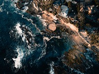 Drone aerial view of the rocky populated coast crashed by the waves at Laguna Beach. Original public domain image from Wikimedia Commons