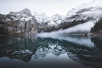 Snowcapped mountains being reflected in the crystal clear Oeschinen Lake. Original public domain image from Wikimedia Commons