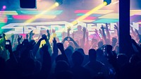 Crowd with raised arms in a colorful club in silhouette. Original public domain image from <a href="https://commons.wikimedia.org/wiki/File:Spag_Heddy_(Unsplash).jpg" target="_blank" rel="noopener noreferrer nofollow">Wikimedia Commons</a>