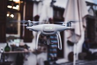 White drone hovering. Original public domain image from <a href="https://commons.wikimedia.org/wiki/File:Drone_(Unsplash).jpg" target="_blank">Wikimedia Commons</a>