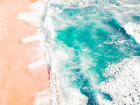 Ocean washing on sand shore, drone view. California. Original public domain image from Wikimedia Commons