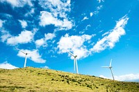 Windmills in a green grassy hillside. Original public domain image from Wikimedia Commons