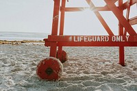 Lower part of lifeguard tower with Lifeguard only written on a sand Daytona Beach. Original public domain image from <a href="https://commons.wikimedia.org/wiki/File:Lifeguard_tower_on_a_beach_(Unsplash_gqvh3l_T6O0).jpg" target="_blank" rel="noopener noreferrer nofollow">Wikimedia Commons</a>