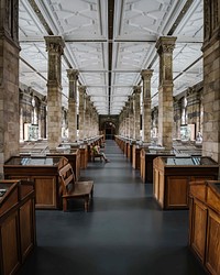 A young man sits on a bench at the Minerals Gallery, Natural History Museum in London.. Original public domain image from Wikimedia Commons