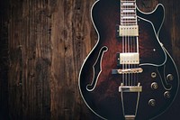 Classic electric guitar on a wooden table. Original public domain image from Wikimedia Commons