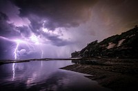 Purple lightning strikes at sea. Original public domain image from Wikimedia Commons