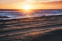 Sunset, sandy, beach, waves, ocean. Original public domain image from Wikimedia Commons