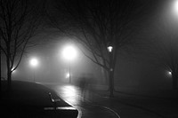 Streetlights glow on a walking path on a foggy night. Original public domain image from Wikimedia Commons