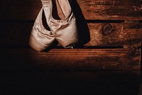 Worn down ballet shoes on a wooden floor. Original public domain image from Wikimedia Commons