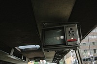 An old electronic television attached to the ceiling of a retro looking bus.. Original public domain image from Wikimedia Commons