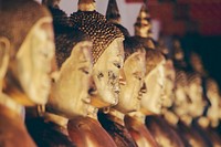 Row of golden statues of Buddha in a religious temple in Bangkok. Original public domain image from Wikimedia Commons