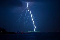 Lightning struck in the city at night. Original public domain image from Wikimedia Commons