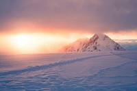 Sun rising over snowy land. Original public domain image from Wikimedia Commons