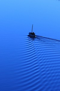 Man riding boat. Original public domain image from Wikimedia Commons