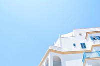 A white Mediterranean-style building under a blue sky. Original public domain image from <a href="https://commons.wikimedia.org/wiki/File:Limassol_Marina_(Cyprus)_(Unsplash).jpg" target="_blank" rel="noopener noreferrer nofollow">Wikimedia Commons</a>