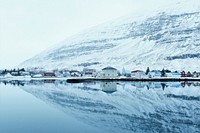 A snowy village reflection in the water with a mountain view. Original public domain image from <a href="https://commons.wikimedia.org/wiki/File:The_reflection_of_a_snowy_mountain_village_(Unsplash).jpg" target="_blank" rel="noopener noreferrer nofollow">Wikimedia Commons</a>
