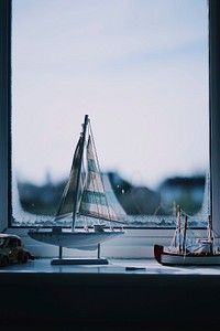 Two boats beside window. Original public domain image from Wikimedia Commons