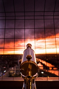 Looking at the sunset behind a telescope in Paris.. Original public domain image from Wikimedia Commons