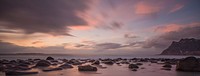 Dusk over the beach with boulders on the shoreline of Uttakleiv Beach. Original public domain image from Wikimedia Commons