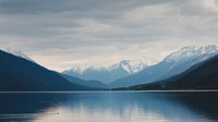 Snowy mountains, blue sea, cloudy, lake. Original public domain image from Wikimedia Commons