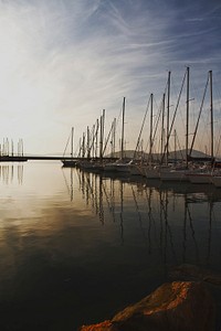 Aligned sail boats near the dock. Original public domain image from Wikimedia Commons